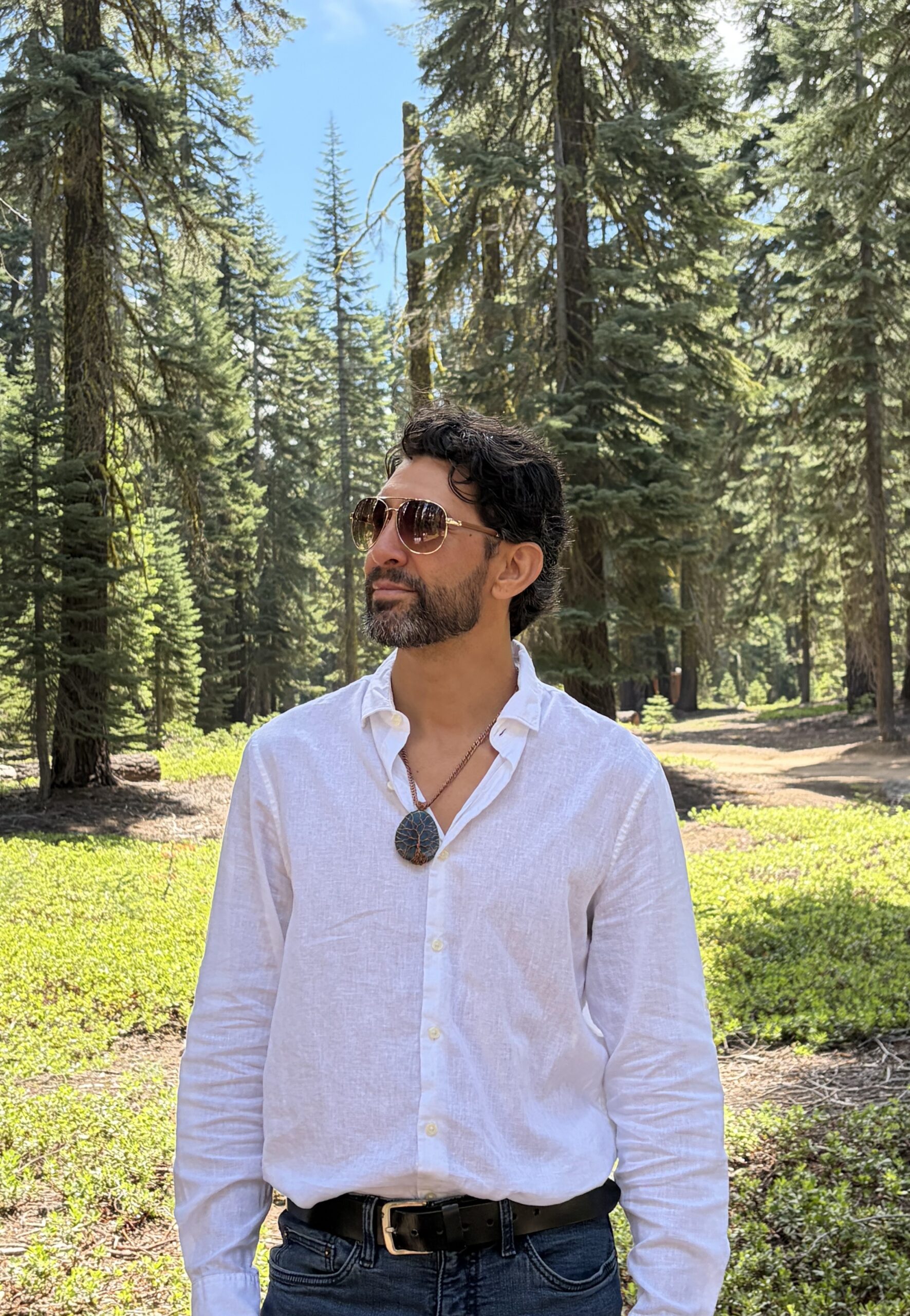 DamiEl Balderrama standing among red fir trees on Mount Shasta